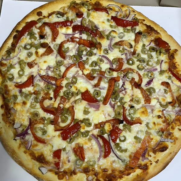 Bella Pizza's whole pizza topped with red peppers, green olives, red onions, and melted cheese.